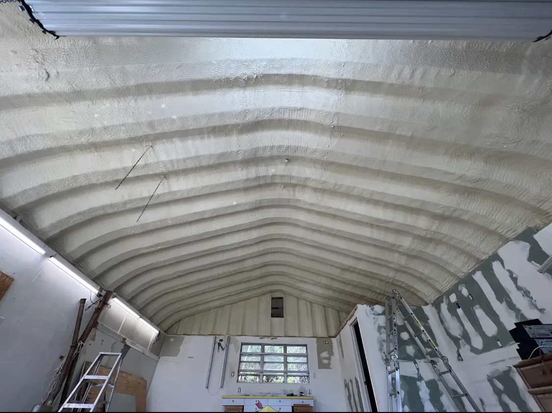 Spray polyurethane foam applied to the underside of a metal roof deck in Pelham Manor